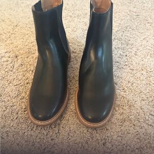 Sleek Black Ankle Boots with Brown Sole